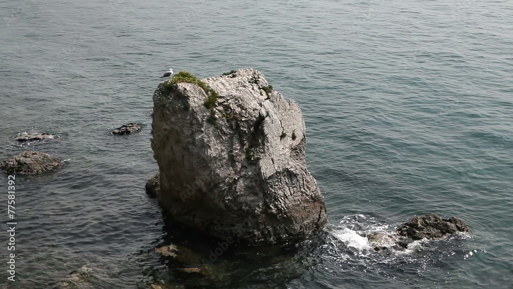 Shot of the big rock in the sea near the coast Shot of the big rock in the sea near the coast