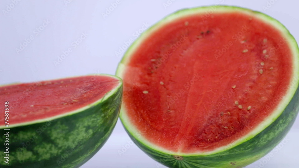Close shot of two parts of watermelon from left to right white background Close shot of two parts of watermelon from left to right white background