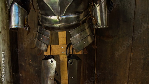 Medieval military armor on a wooden stand
 photo