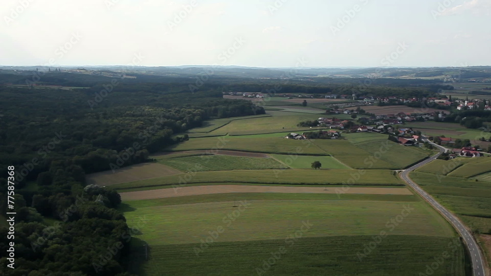 Panorama slide shot from helicopter representing hills and valley in the middle that is populated with some houses Panorama slide shot from helicopter representing hills and valley in the middle that is populated with some houses