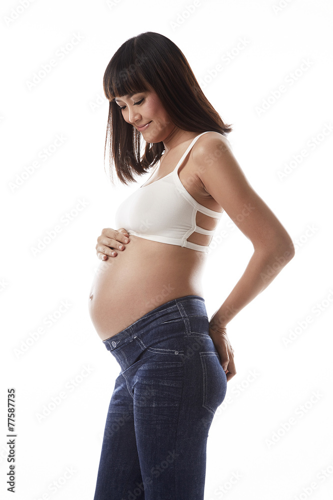 Asian pregnant woman look at her belly Asian pregnant woman look at her belly