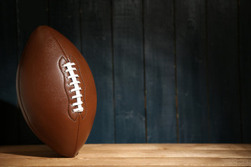 American football on wooden table, close up