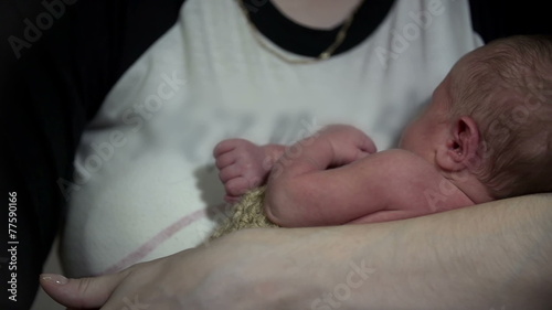 Mother tempering her small purple baby photo