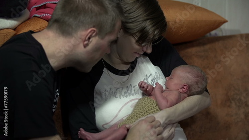 Parents fondle their newborn photo