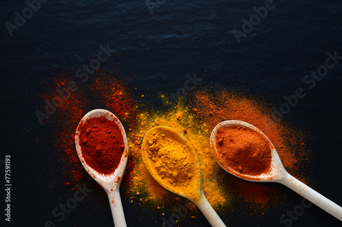 Colorful spices on cooking spoons