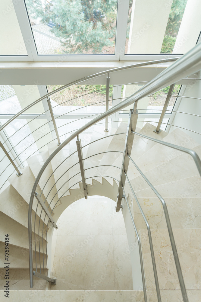 Fototapeta premium Spiral marble stairs in apartment