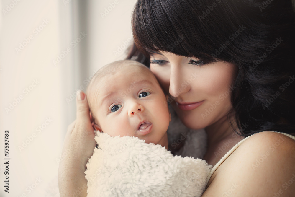 Young mother with her baby in her arms.