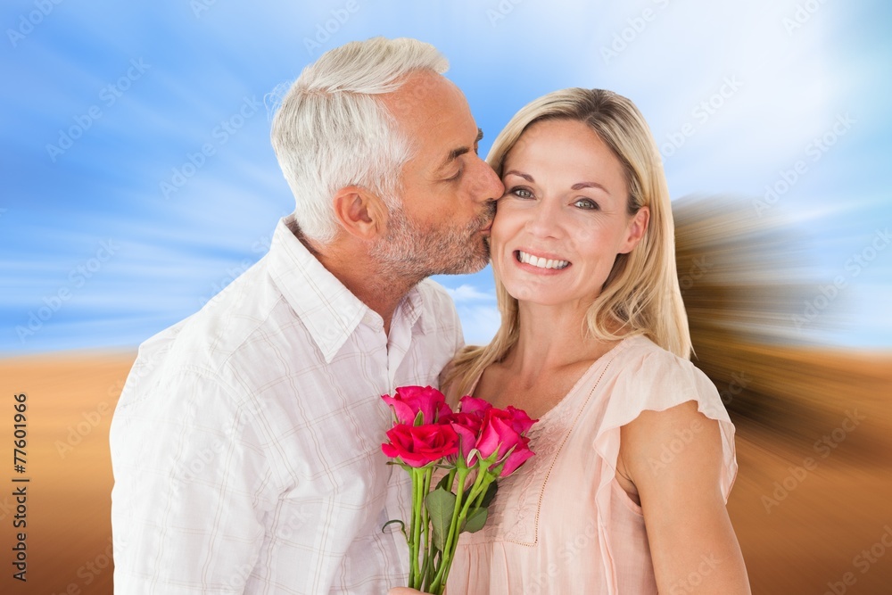 Affectionate man kissing his wife on the cheek with roses Affectionate man kissing his wife on the cheek with roses