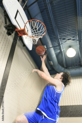 A teenager basketball player play his favorite sport