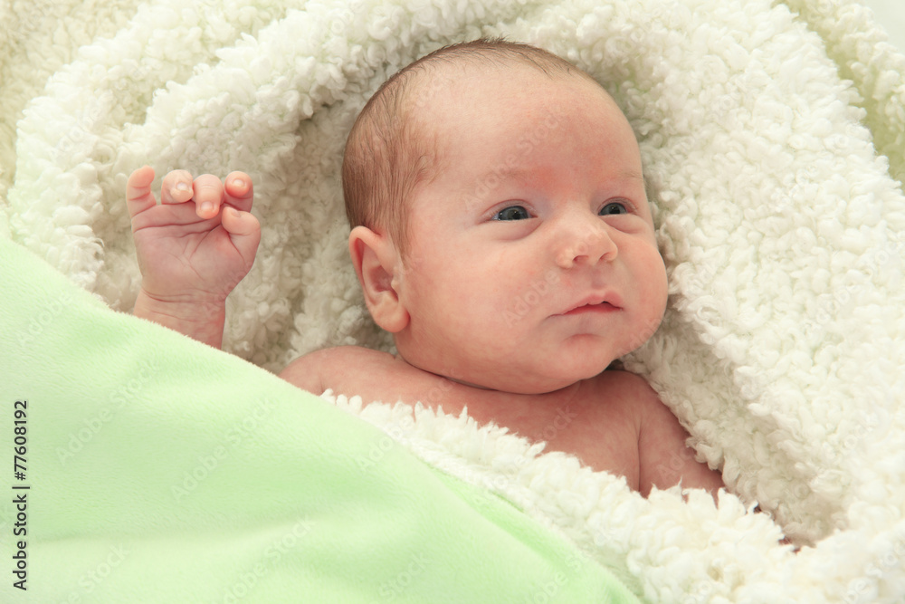 Adorable naked baby boy with blue eyes, lying on soft fur Adorable naked baby boy with blue eyes, lying on soft fur
