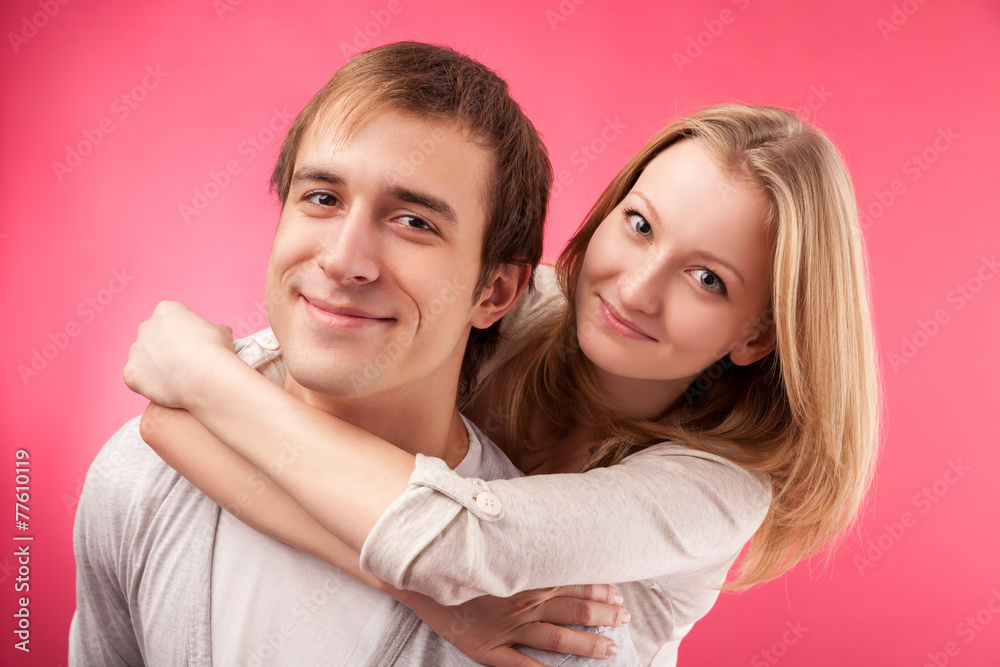 smiling couple hugging, looking in the camera smiling couple hugging, looking in the camera
