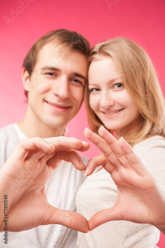 Couple making shape of heart by their hands