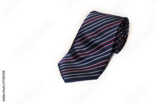 Folded striped necktie on a white background