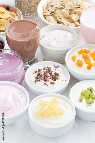 Assorted fresh fruit yoghurts and breakfast ingredients