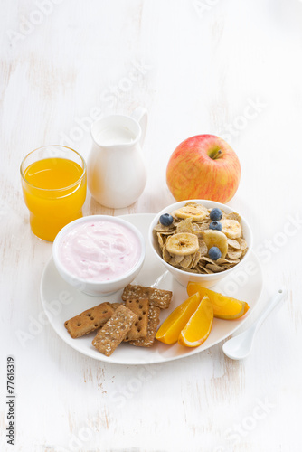 healthy breakfast - cereal, fruit, yogurt and juice, vertical