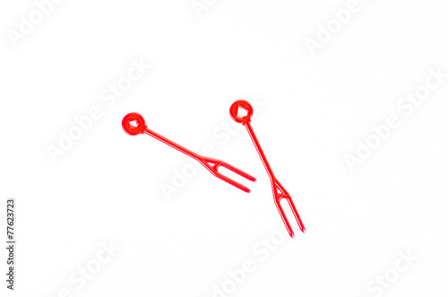 red plastic food skewer on white background