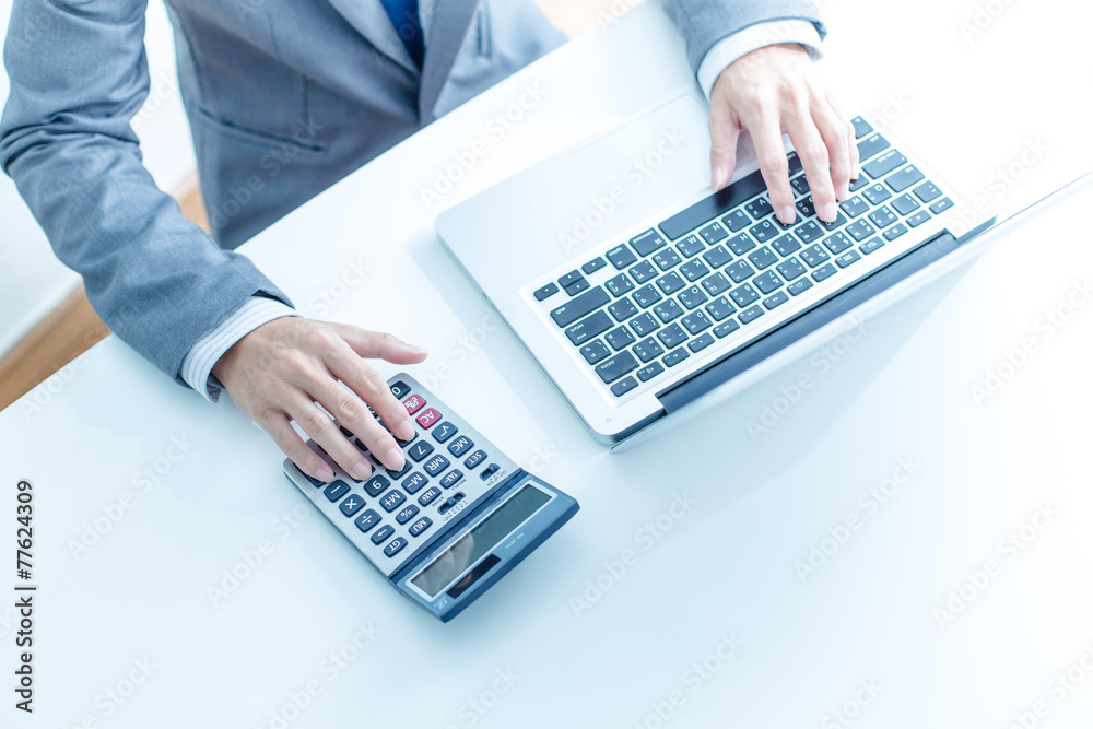 Closeup of businessman hands typing on laptop computer Closeup of businessman hands typing on laptop computer