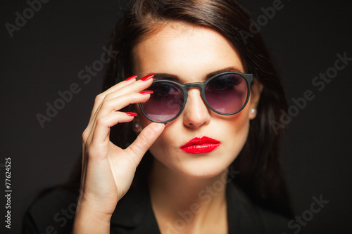 Glamour woman with sunglasses, red lips and nails