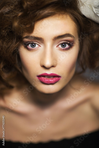 Portrait of a beautiful woman with long brown hair and makeup