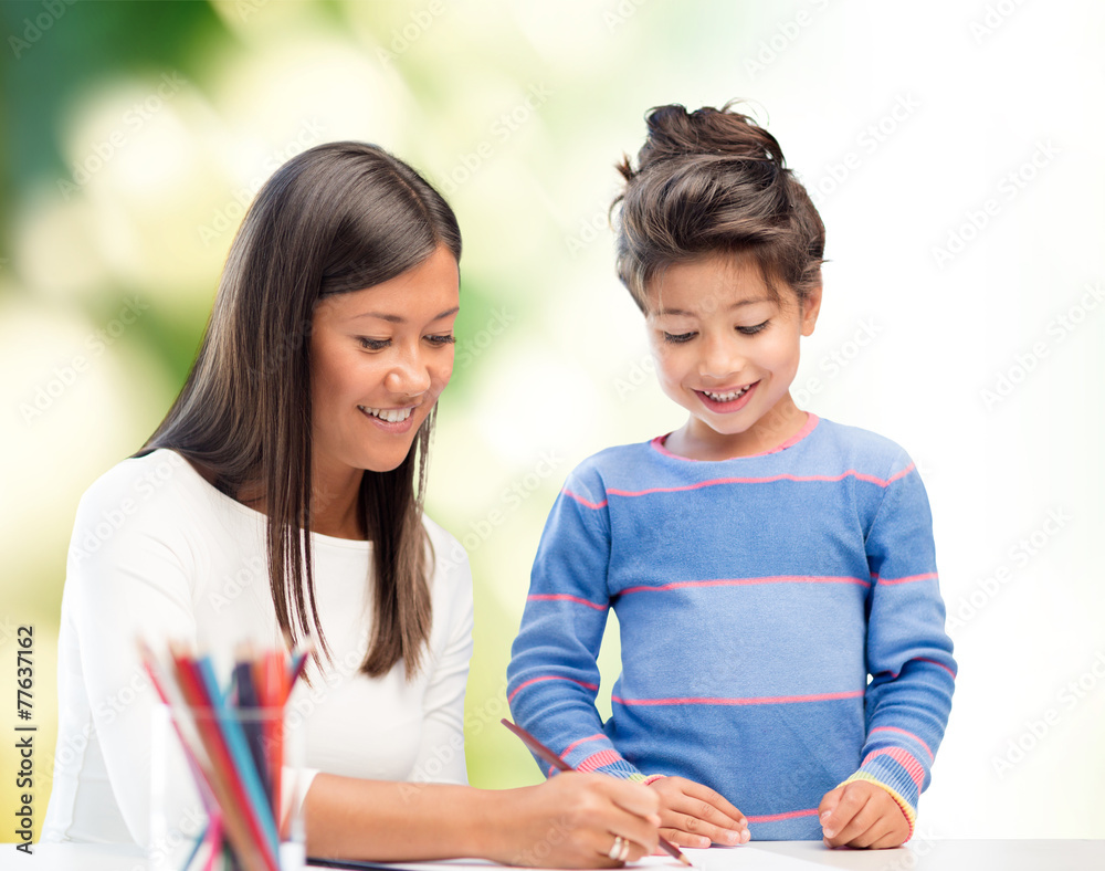 happy mother and daughter drawing with pencils happy mother and daughter drawing with pencils
