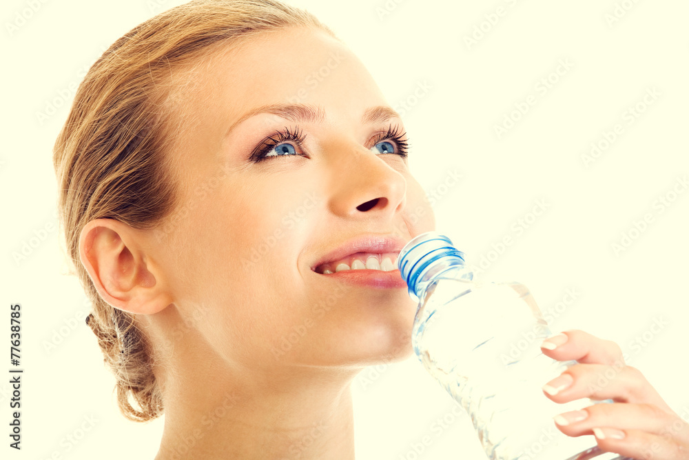 Portrait of beautiful young blond woman drinking water Portrait of beautiful young blond woman drinking water