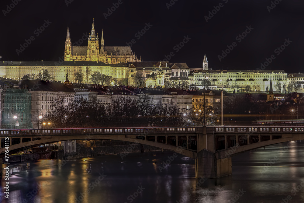 Prague Castle illuminated at night over the river Vltava