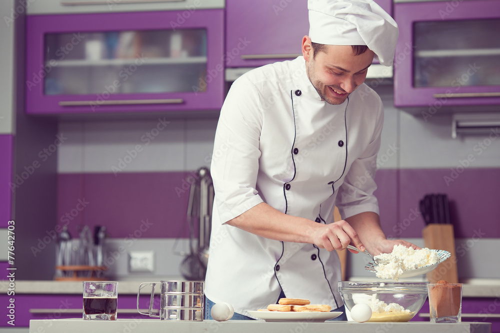 Tiramisu cooking concept. Smiling man in cook uniform Tiramisu cooking concept. Smiling man in cook uniform