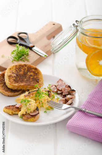 Scrambled eggs with French toast topped with watercress