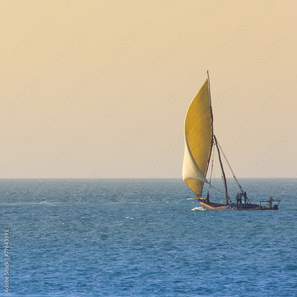 Fototapeta premium Wooden sailboat (dhow) on the clear turquoise water of Zanzibar