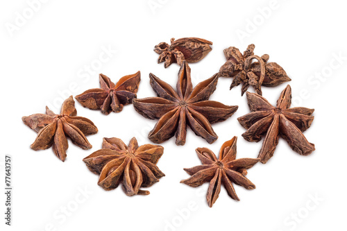 Closeup of several star anises isolated on white background