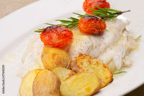 Fish dish - fish fillet in sauce and vegetables