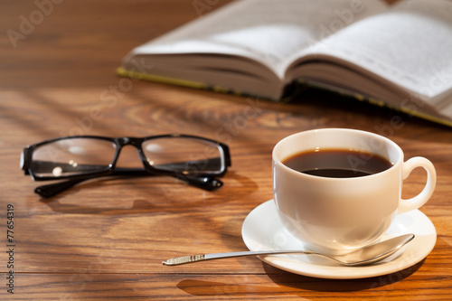 Cup of coffee, book and glasses