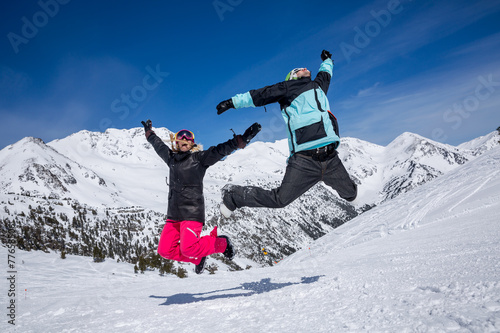 Happy couple jumping in mountains