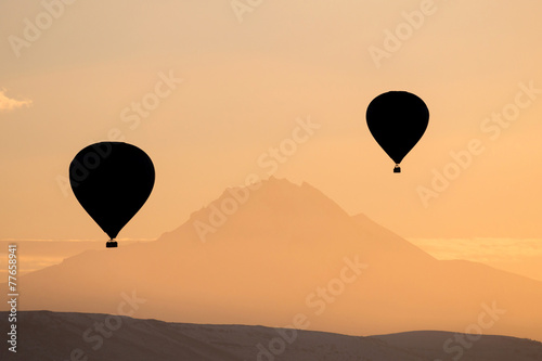 Silhouette of hot air balloons fly over Cappadocia.