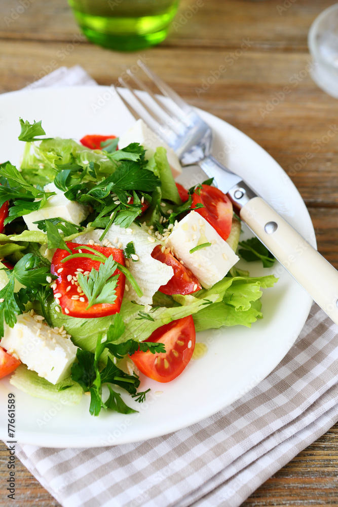 Salad with tomatoes, peppers and cheese on a plate Salad with tomatoes, peppers and cheese on a plate