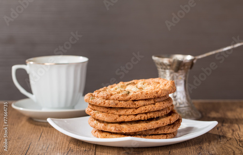 Cup of coffee with tasty cookies and turk for coffee