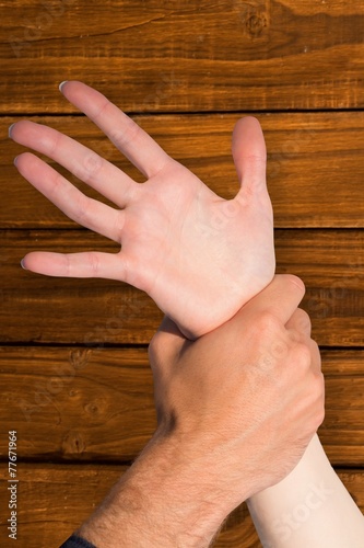 Composite image of womans wrist held by man