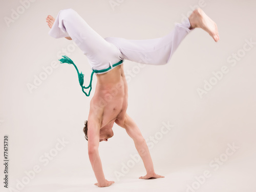 Capoeira dancer on white background