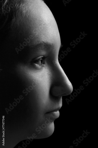 teen girl profile portrait on black background