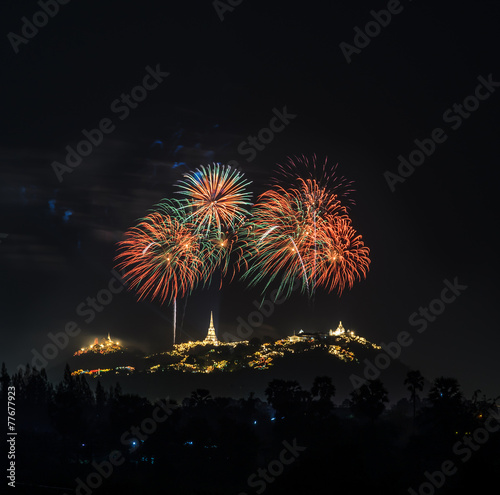 Colorful firework over temple on hill, Thailand © boonsom