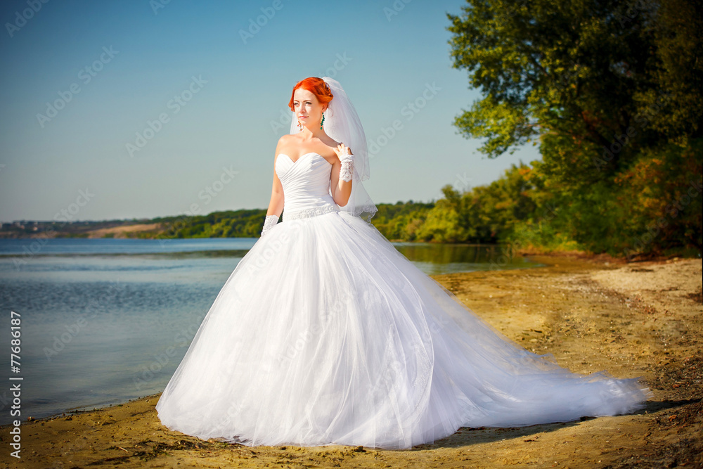 Portrait of beautiful bride standing by the beach