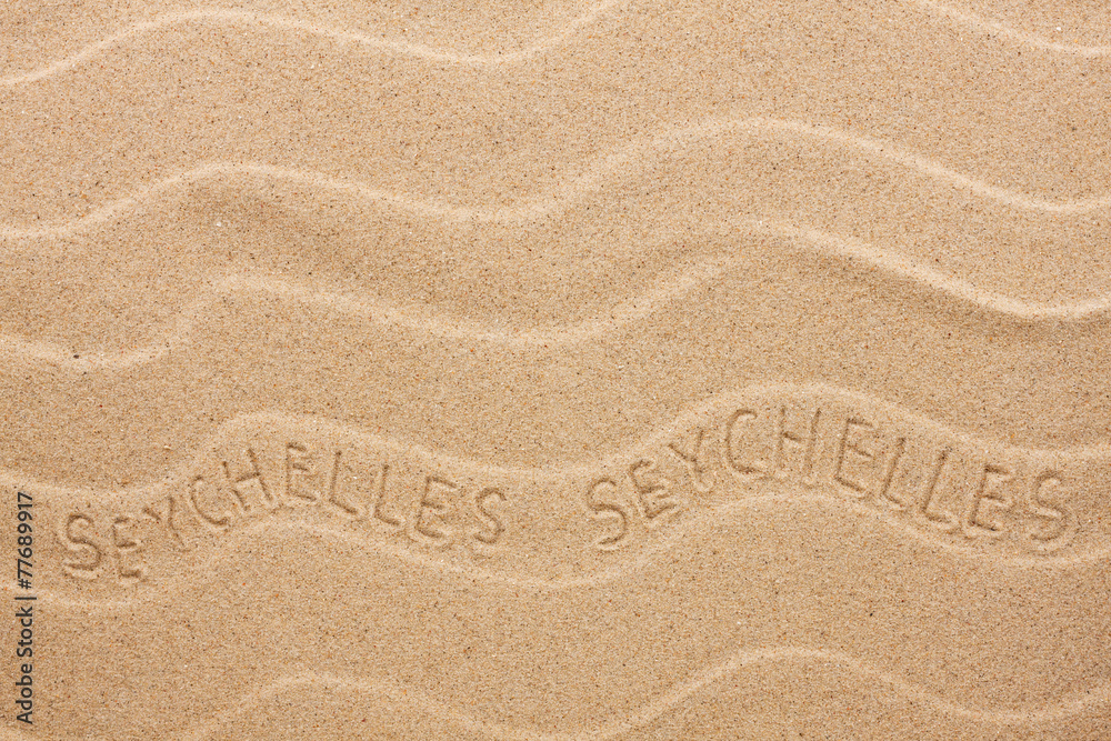 Seychelles inscription on the wavy sand Seychelles inscription on the wavy sand