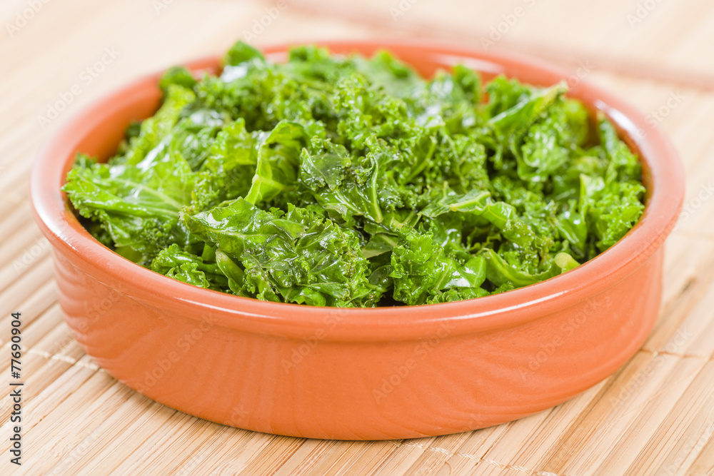 Curly Kale - Cooked cale in an earthenware dish. Curly Kale - Cooked cale in an earthenware dish.