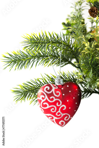christmas toy in the form of heart on a branch