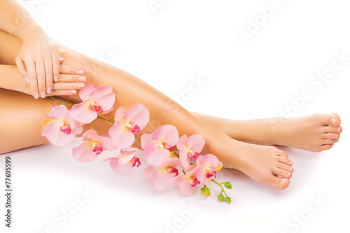 Relaxing manicure and pedicure with a pink orchid flower