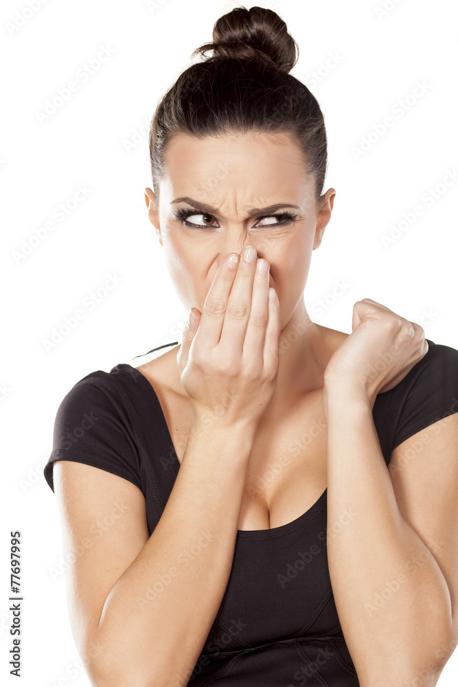 worried woman checks her breath with the hand worried woman checks her breath with the hand