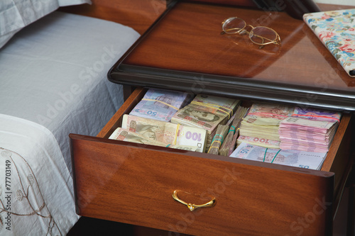 Bundles of banknotes in bedside table photo