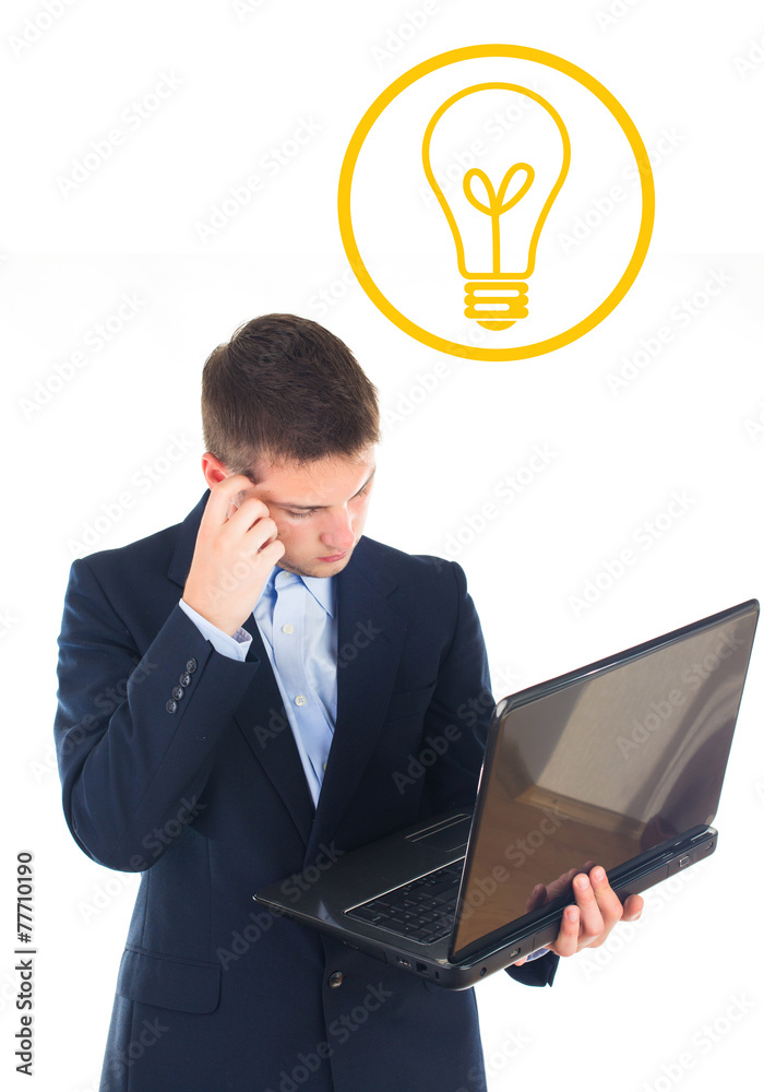 Portrait of young thinking business man with laptop in suit - is
