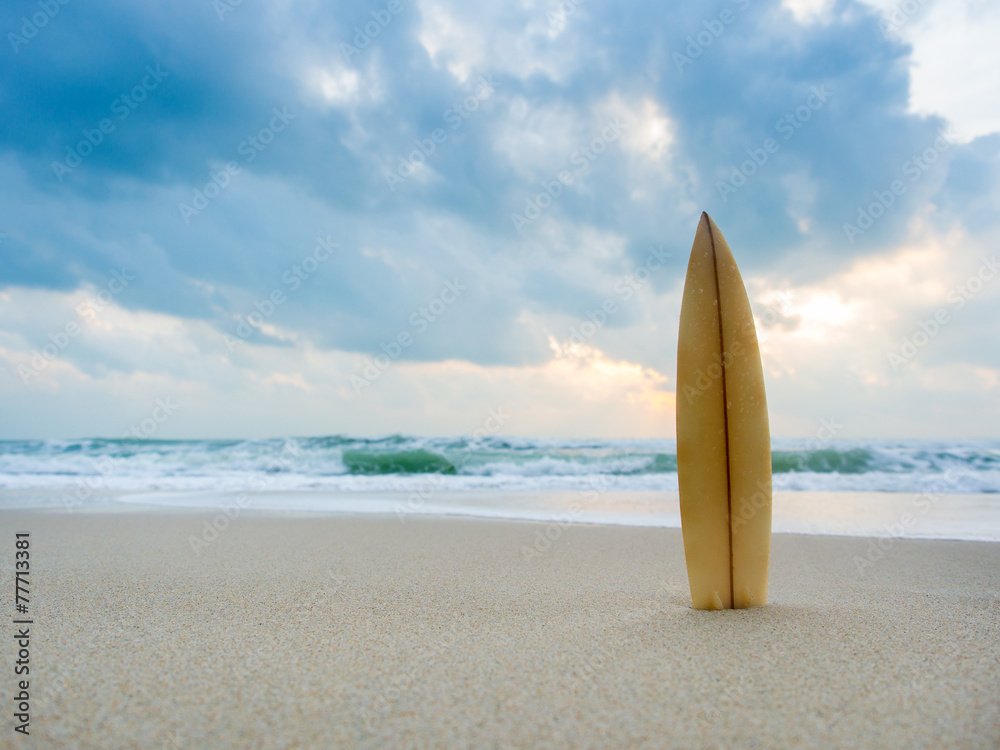 Surfboard on the beach at sunset Surfboard on the beach at sunset