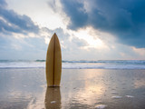 Surfboard on the beach at sunset
